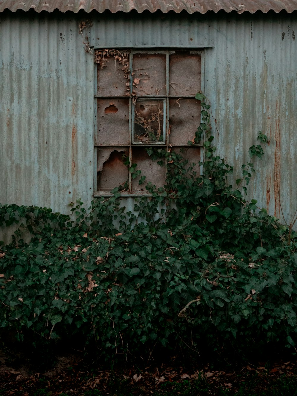 an old run down building with a broken window