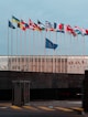 a bunch of flags that are in front of a building