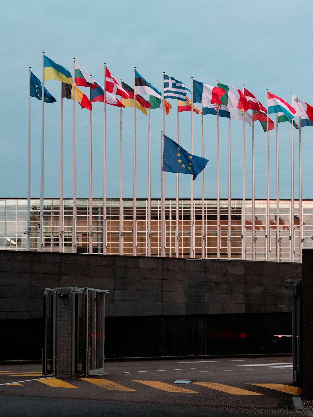 a bunch of flags that are in front of a building