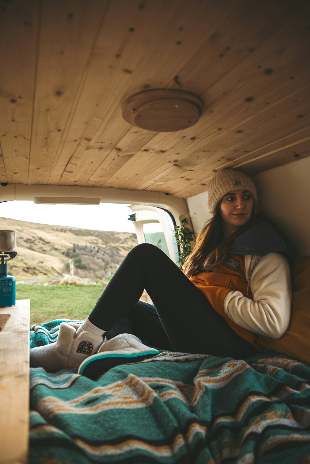 a woman sitting in the back of a truck