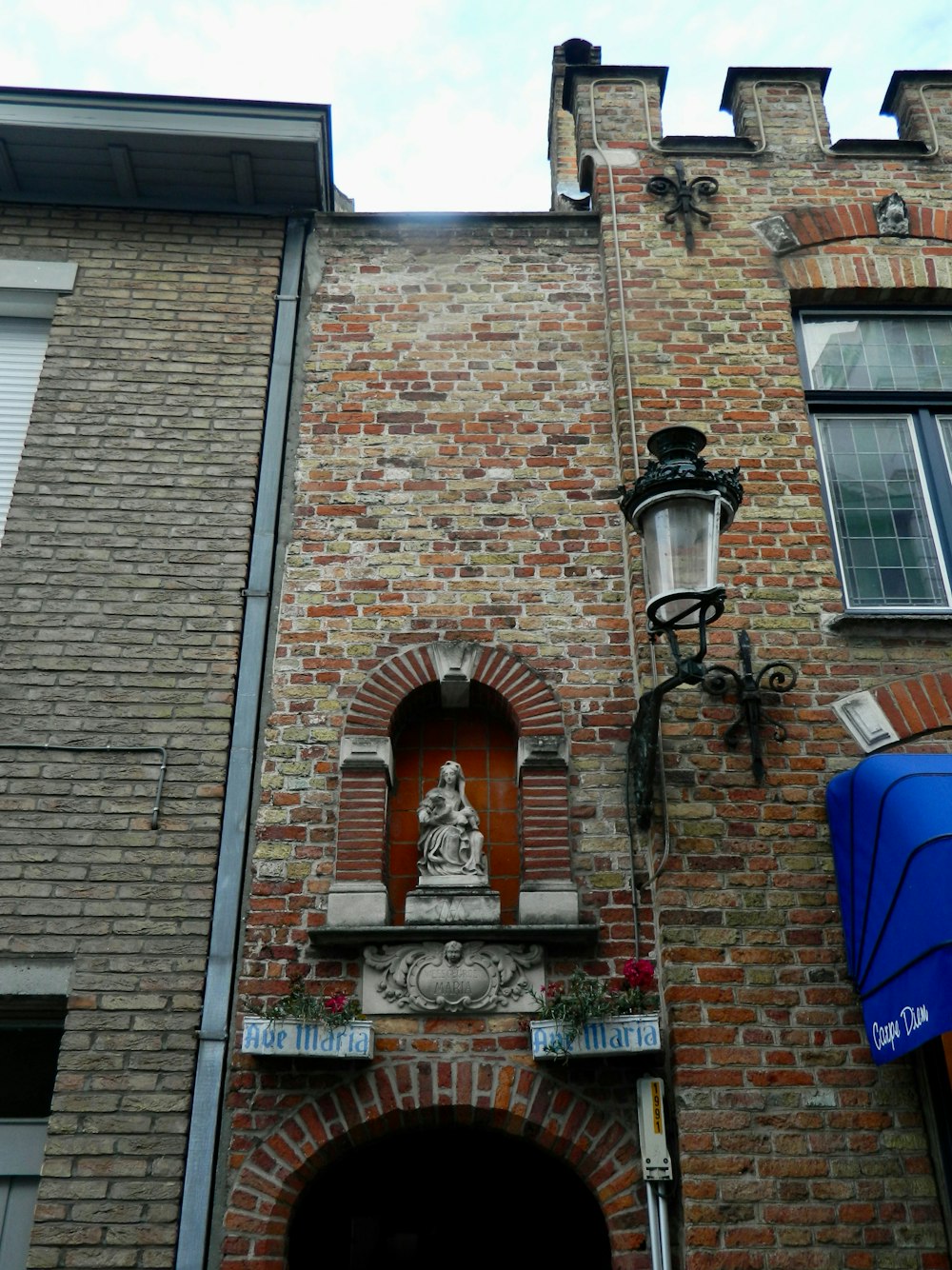 a tall brick building with a clock on it's side