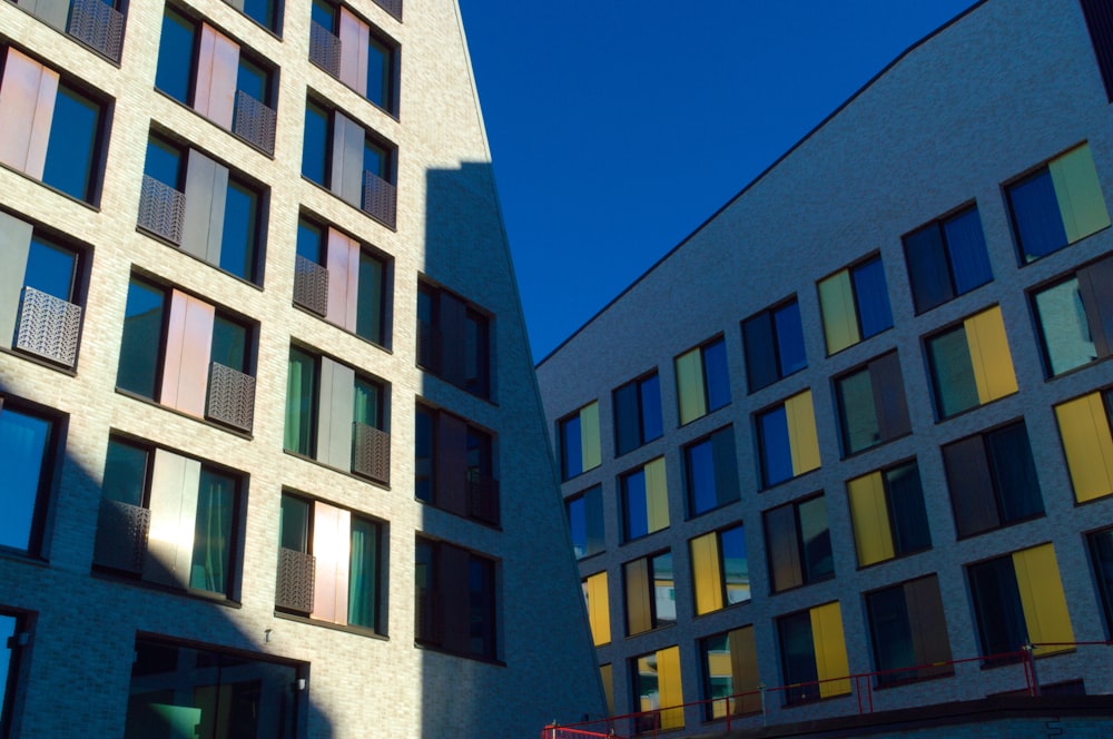 a tall building with lots of windows next to another building