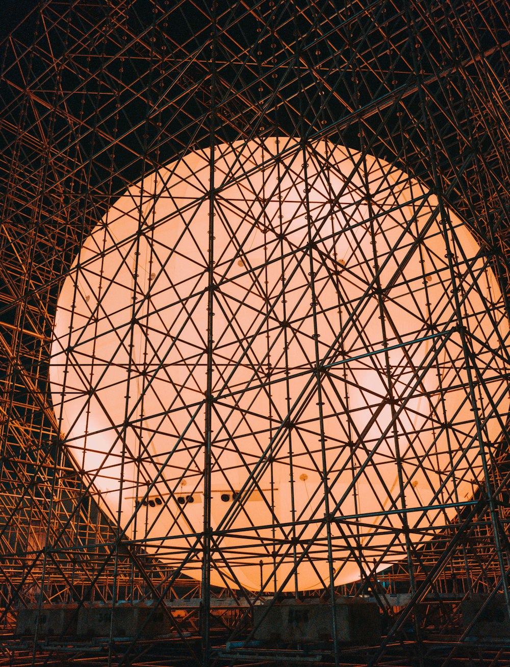 a large circular structure with many scaffolding around it
