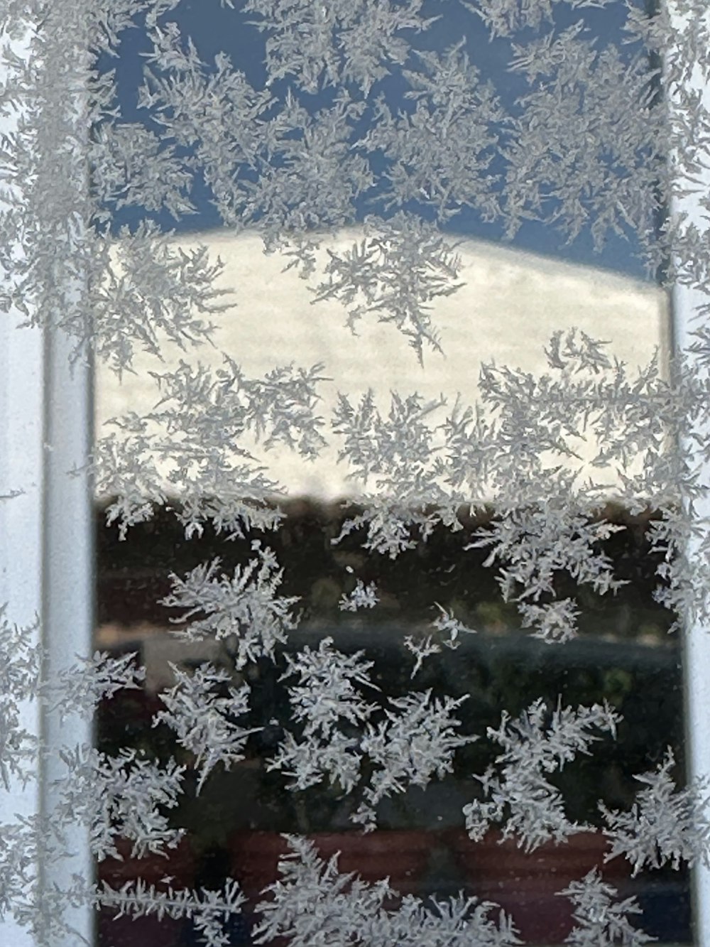 a window with frosted glass and a building in the background