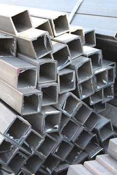a pile of steel pipes stacked on top of each other