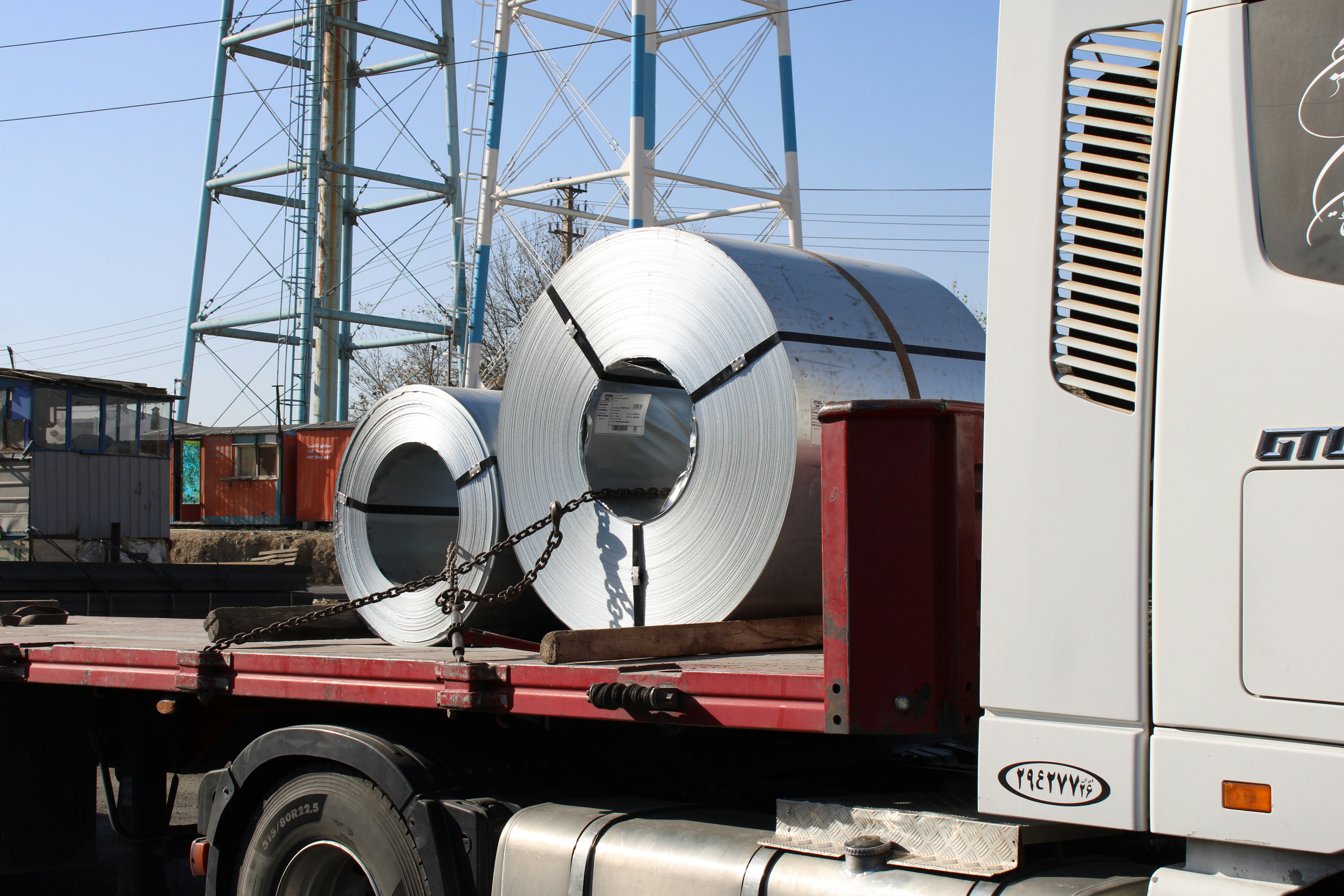 a truck with a large roll of metal on the back of it