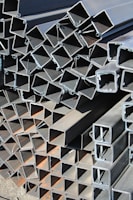 a pile of steel pipes stacked on top of each other