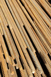 a pile of rusty nails sitting on top of a wooden floor