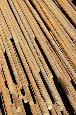 a pile of rusty nails sitting on top of a wooden floor