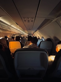 a group of people sitting inside of an airplane