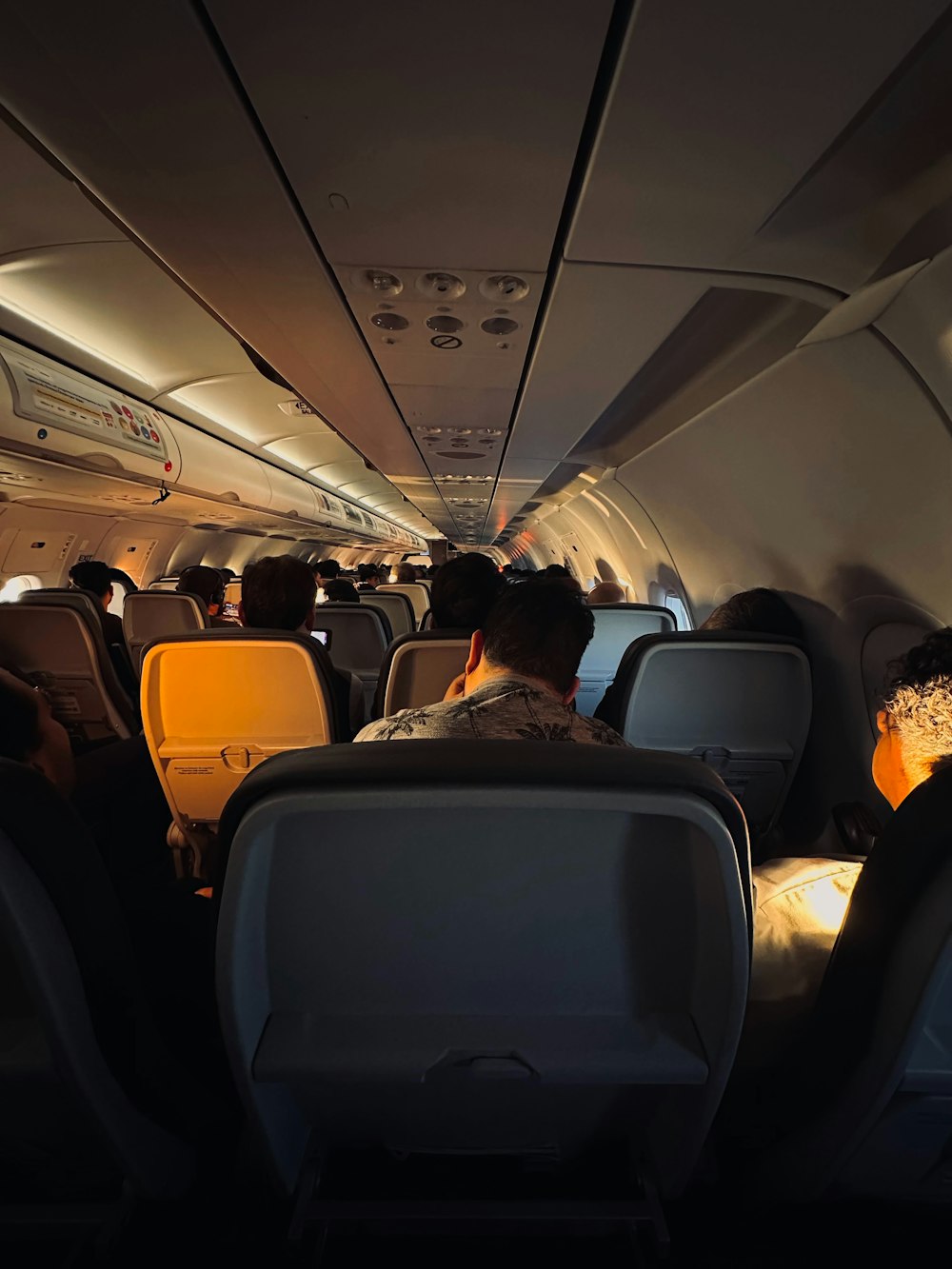 a group of people sitting inside of an airplane