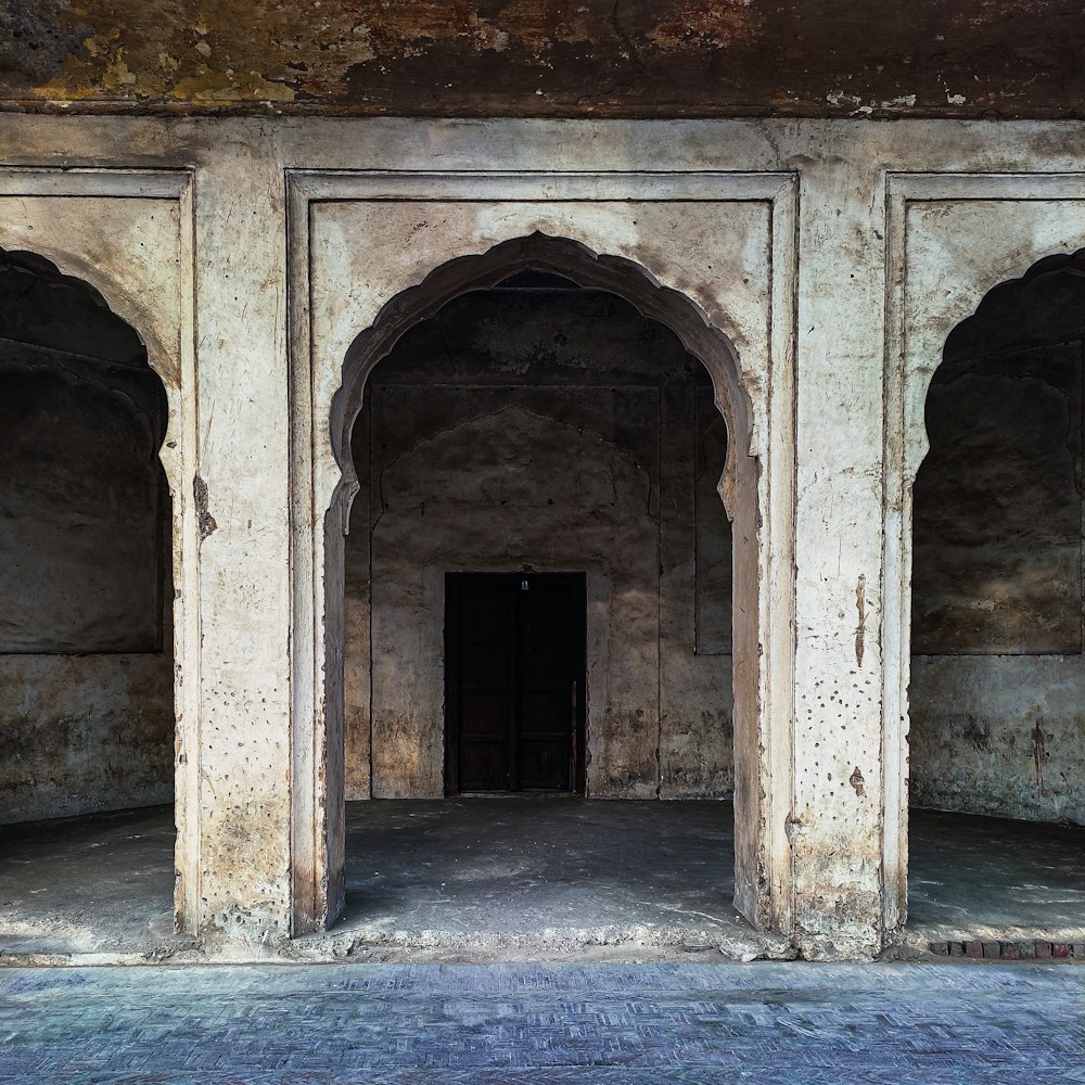 an old building with arches and a doorway