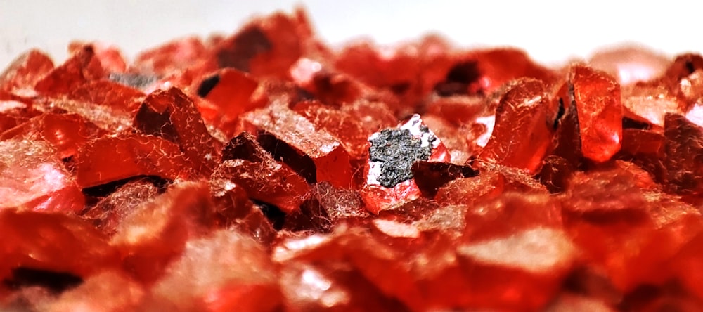 a pile of red crystals sitting on top of a table