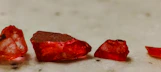a group of red rocks sitting on top of a table