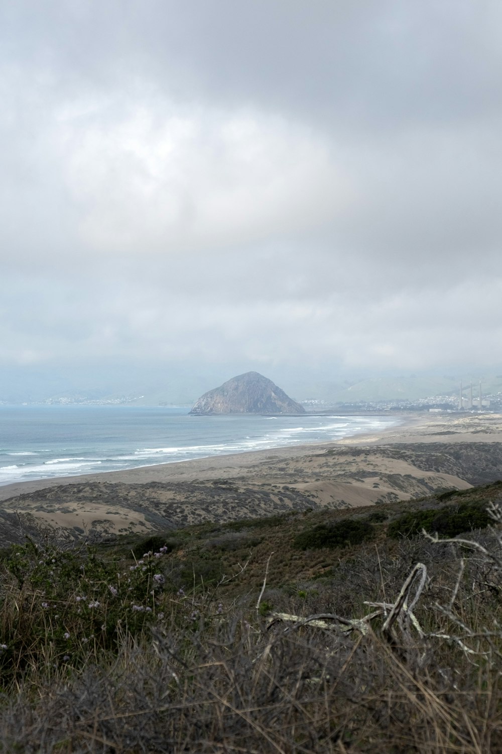 a view of a beach with a mountain in the distance