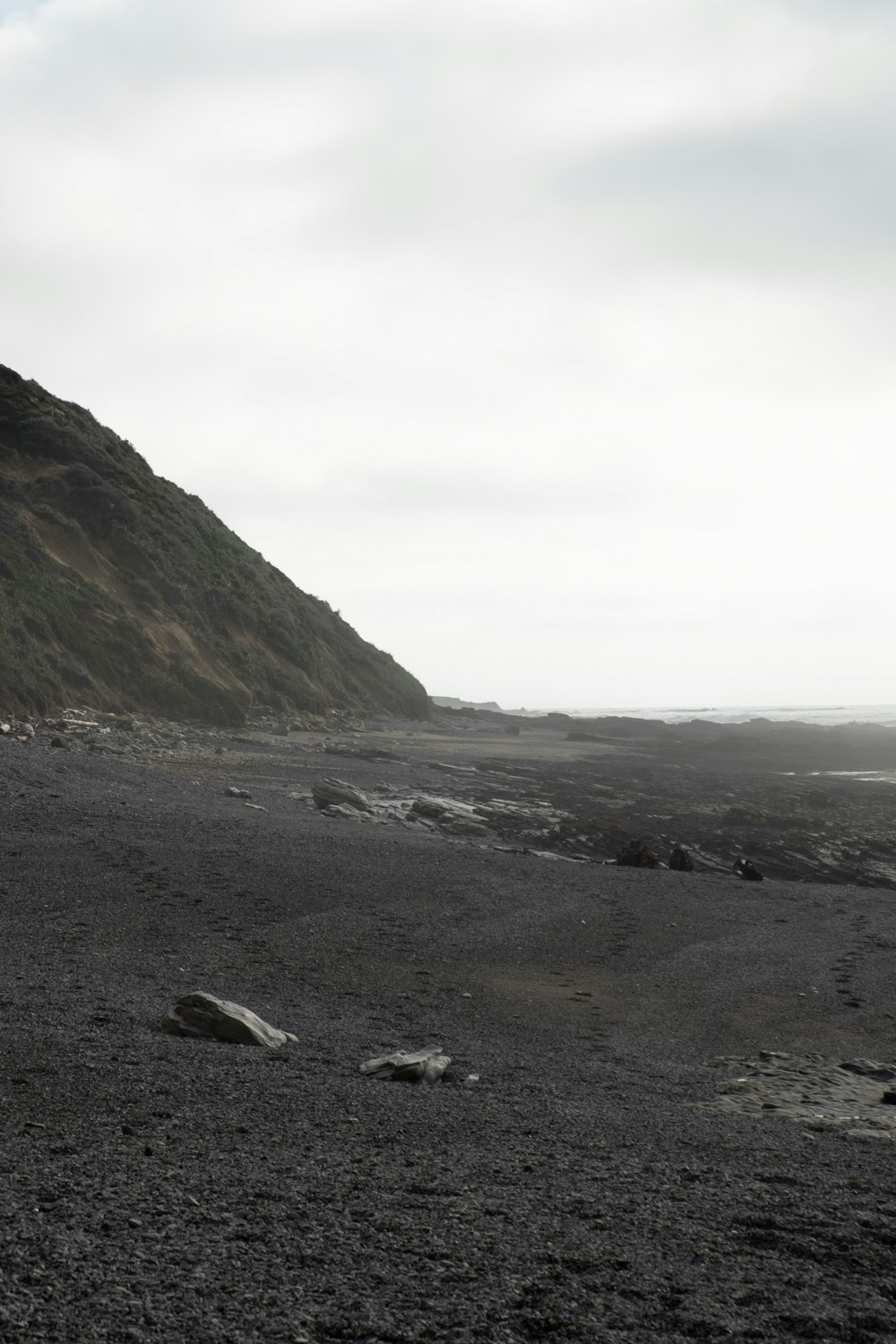 a black and white photo of a rocky beach