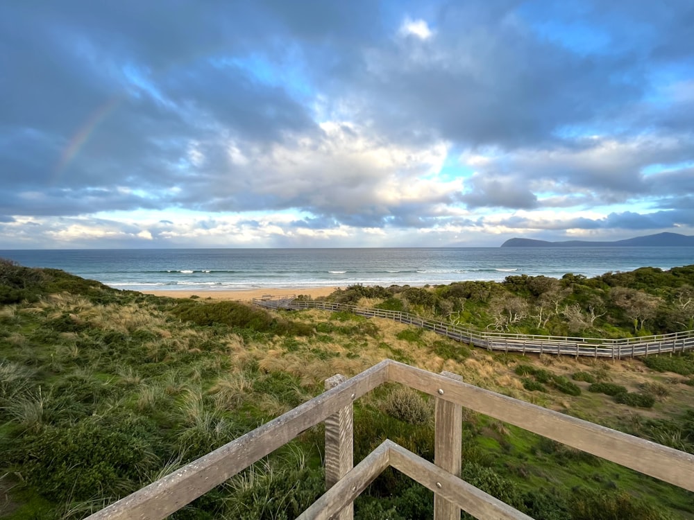 a view of the ocean from a wooden deck