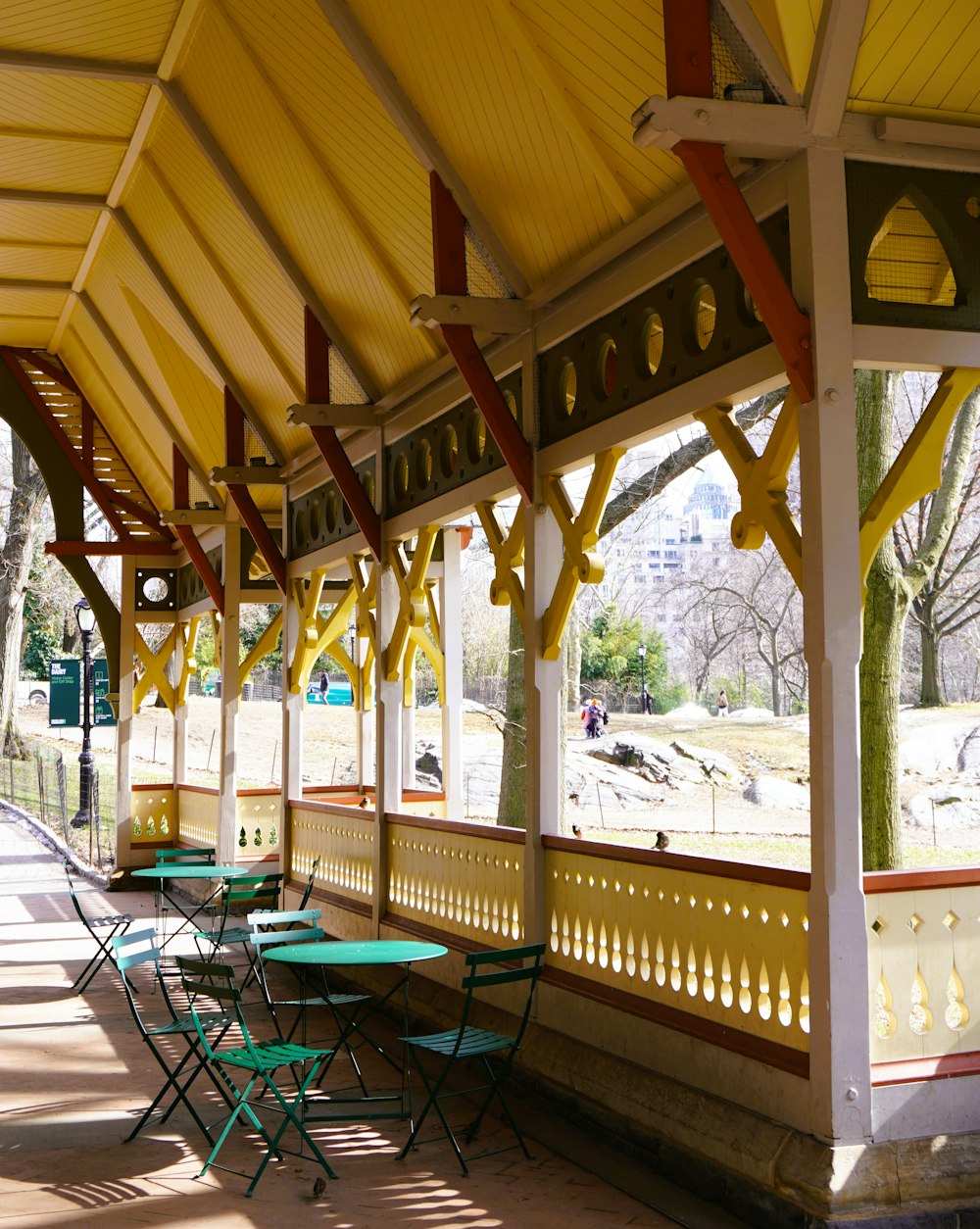 a covered area with tables and chairs under a canopy