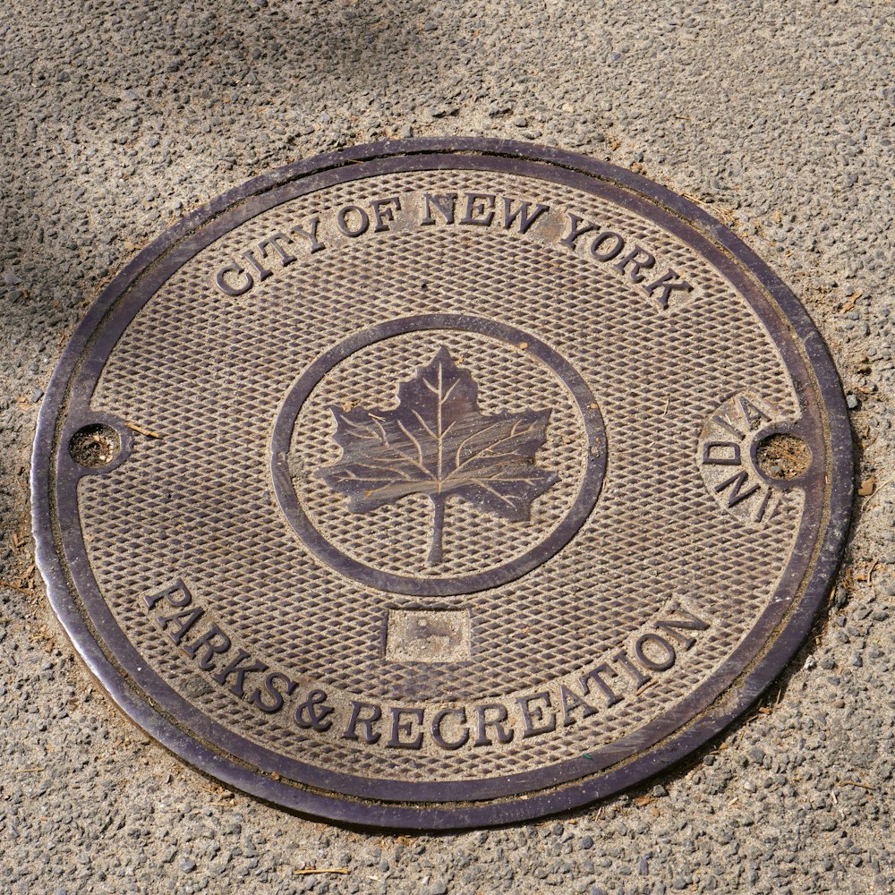 a manhole cover with a maple leaf on it