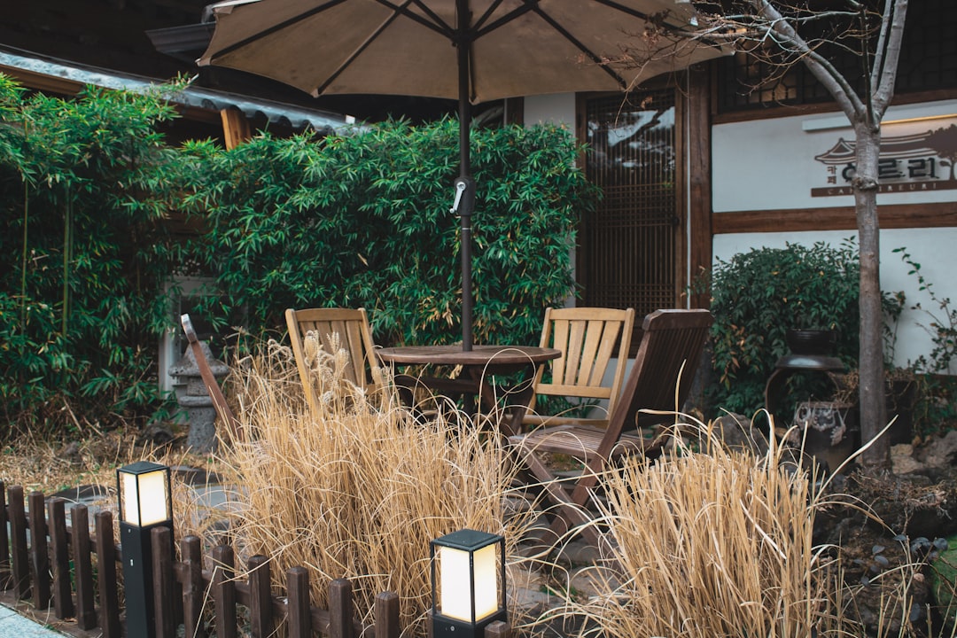 a couple of chairs sitting under an umbrella,