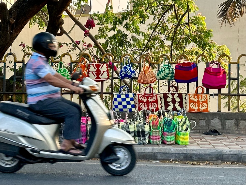 a man riding a scooter down a street