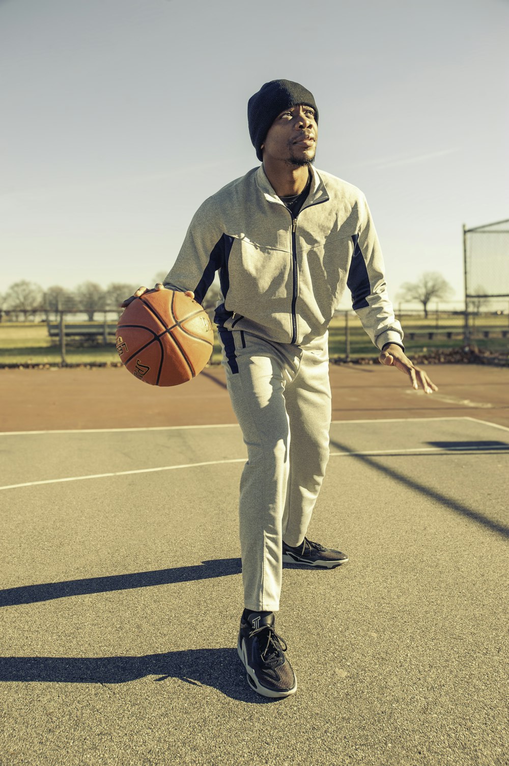 a man holding a basketball on a basketball court