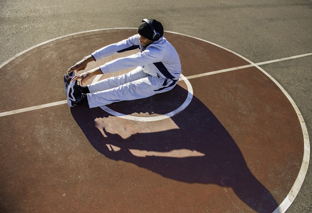 a man riding a skateboard on top of a basketball court