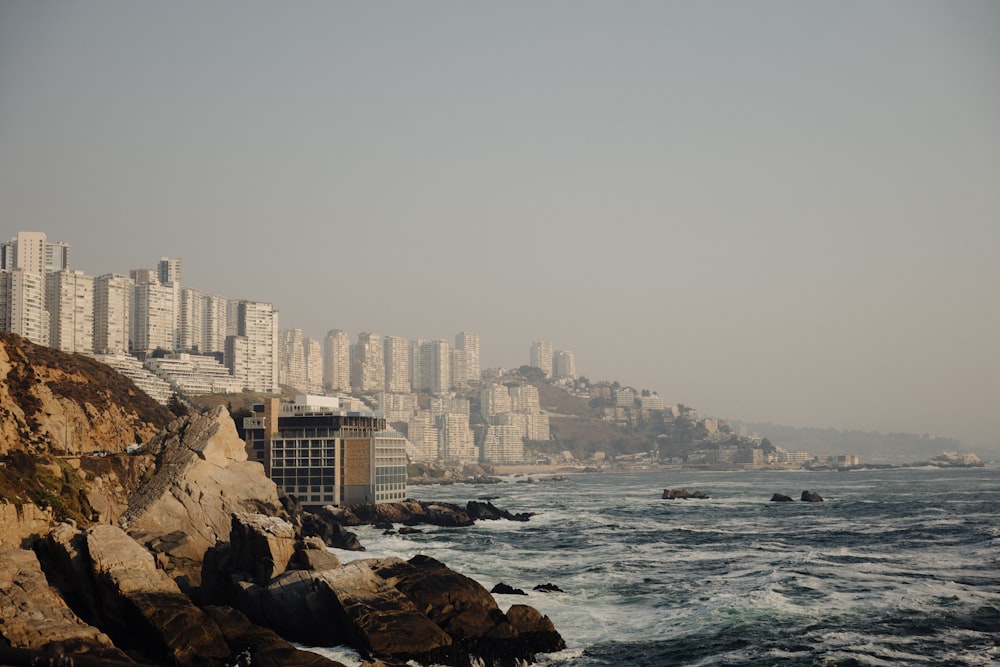 a large body of water with a city in the background