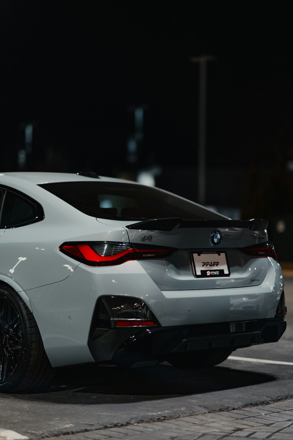 a white car parked in a parking lot at night