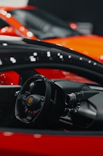a close up of a steering wheel and dashboard of a sports car
