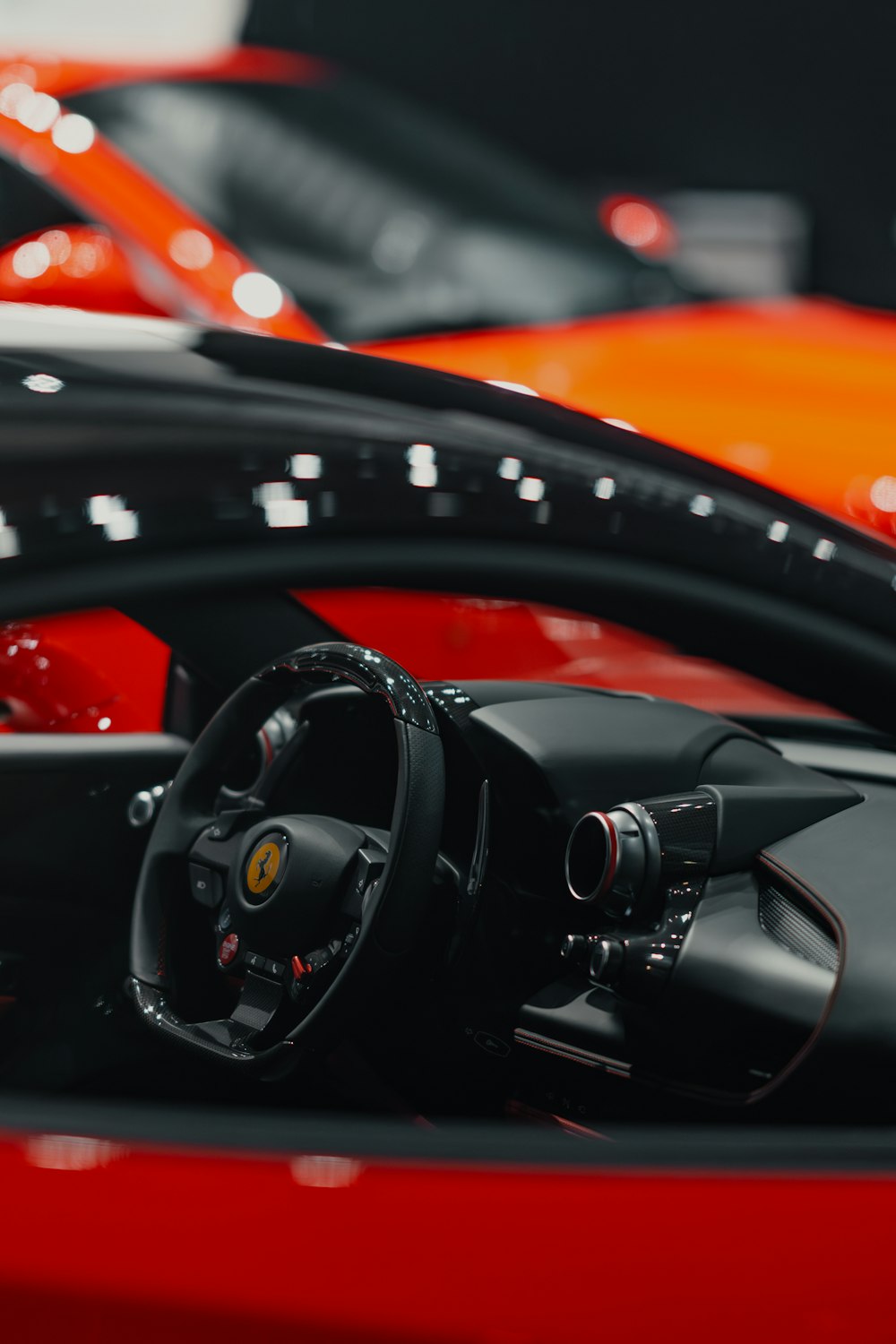 a close up of a steering wheel and dashboard of a sports car