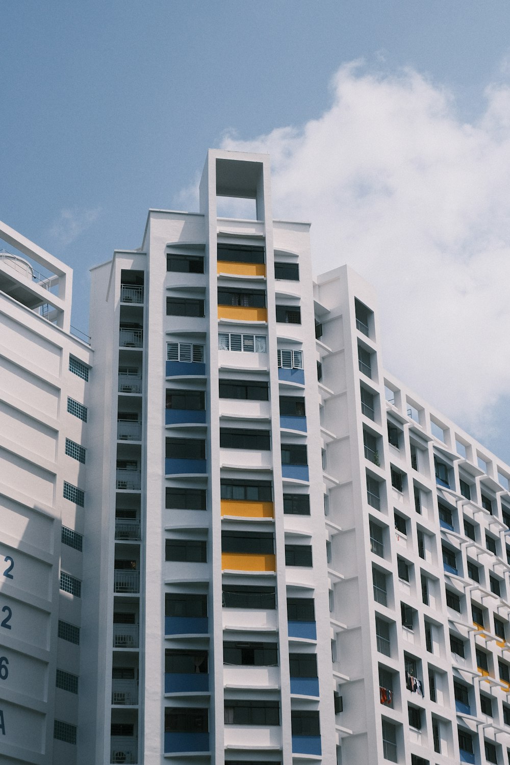 a tall white building sitting next to a tall white building