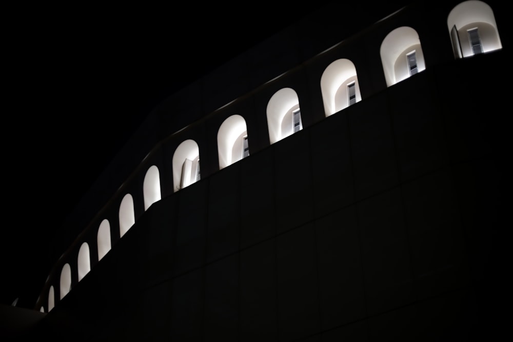 a building with a lot of windows lit up at night