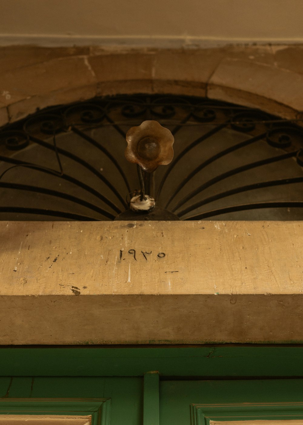 a green door with a flower on top of it