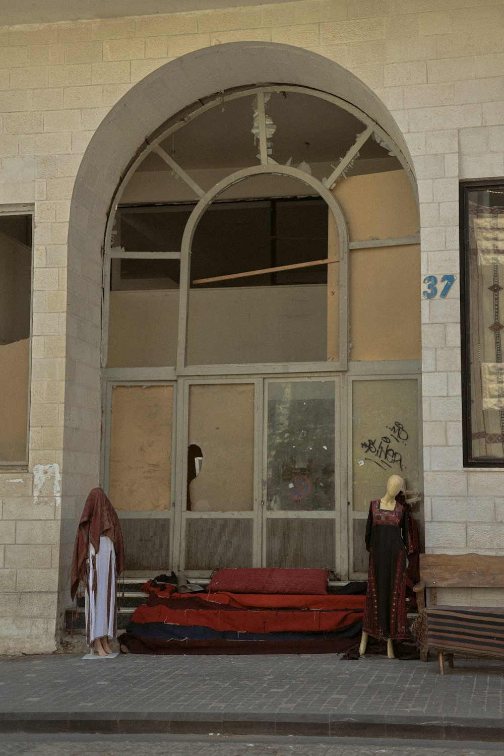 a couple of mannequins are standing in front of a building