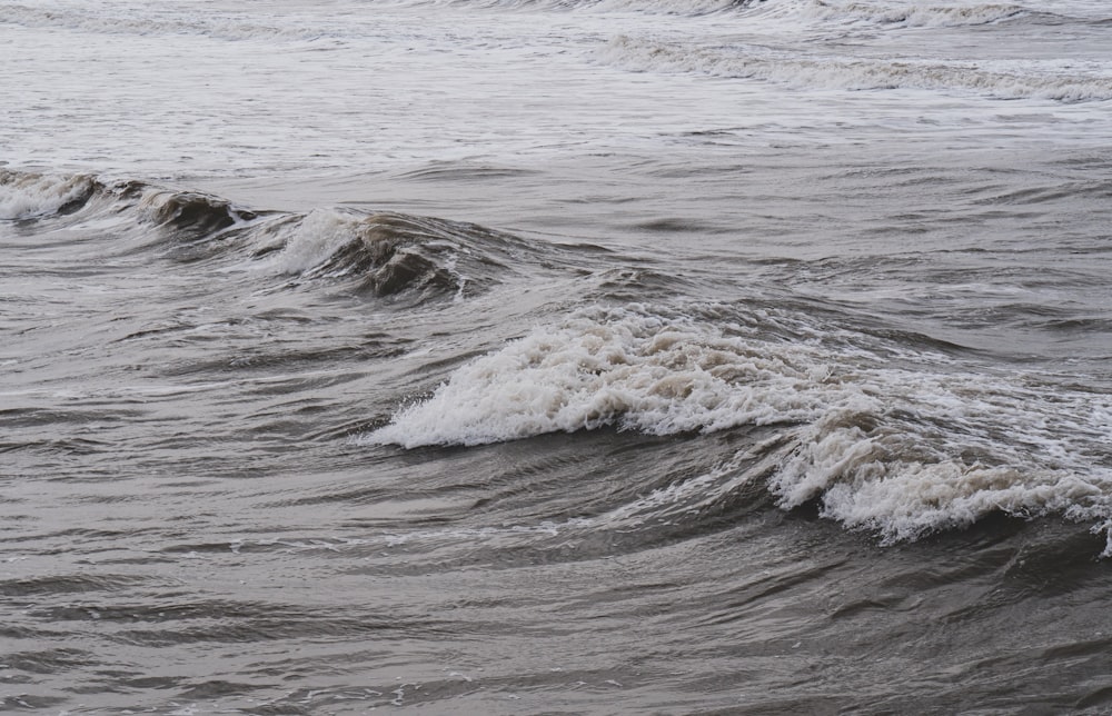 a person riding a surfboard on a wave in the ocean