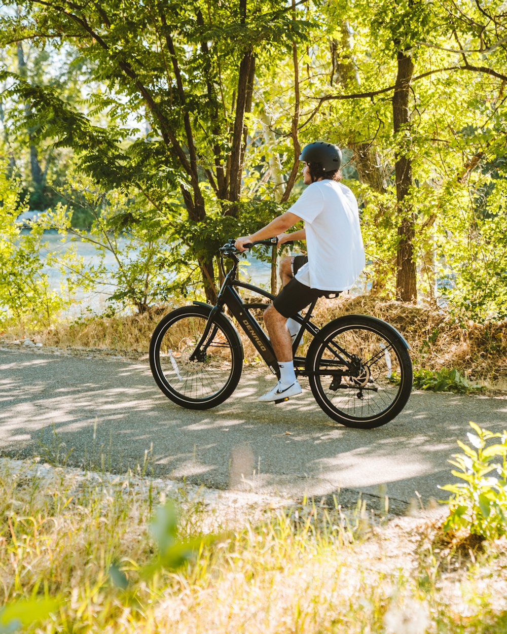 a man riding a bike on a path in the woods