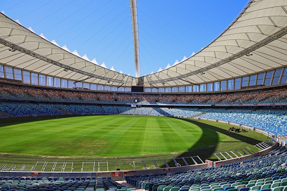 a large stadium filled with lots of blue seats