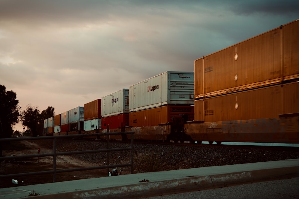 a train traveling down train tracks next to a forest