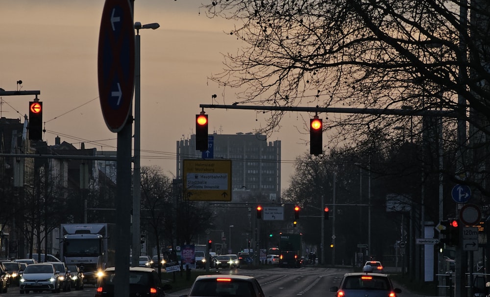 a street filled with lots of traffic next to tall buildings