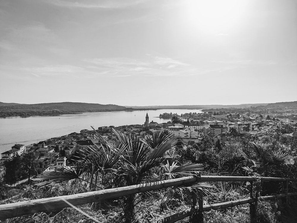 a black and white photo of a town and water