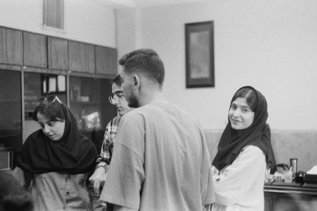 a group of people standing around each other