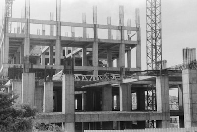 a black and white photo of a building under construction