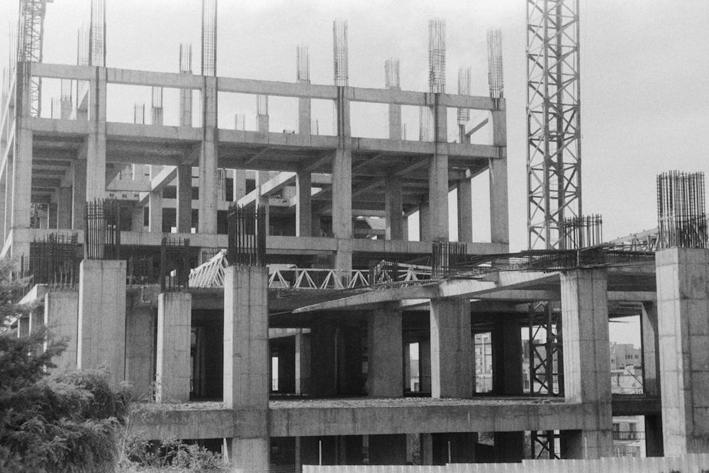 a black and white photo of a building under construction