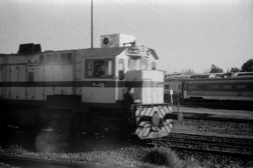 a black and white photo of a train on the tracks