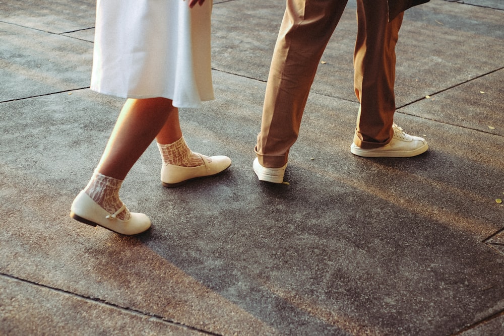 a couple of people that are standing on a sidewalk