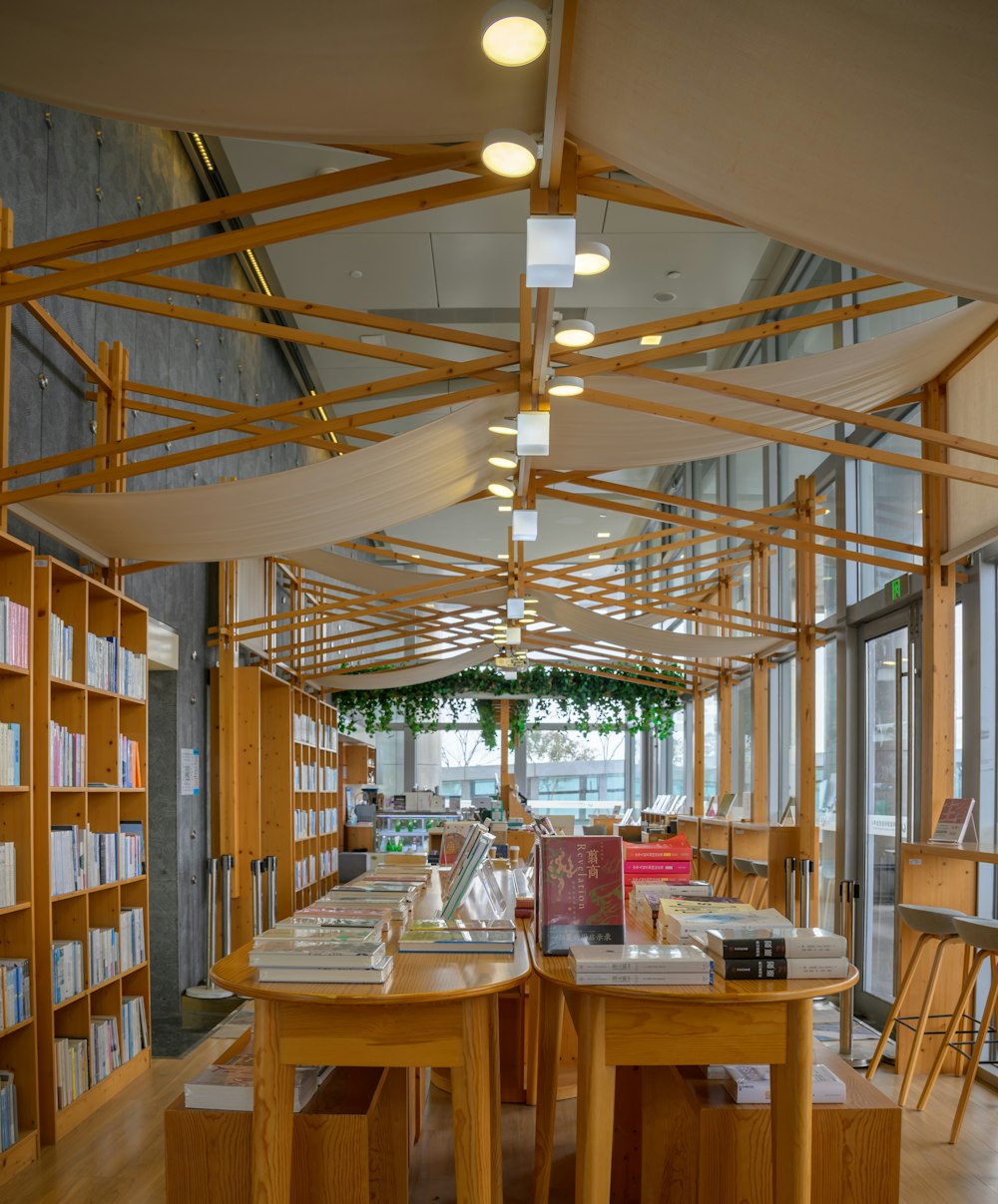 a library filled with lots of books and wooden tables