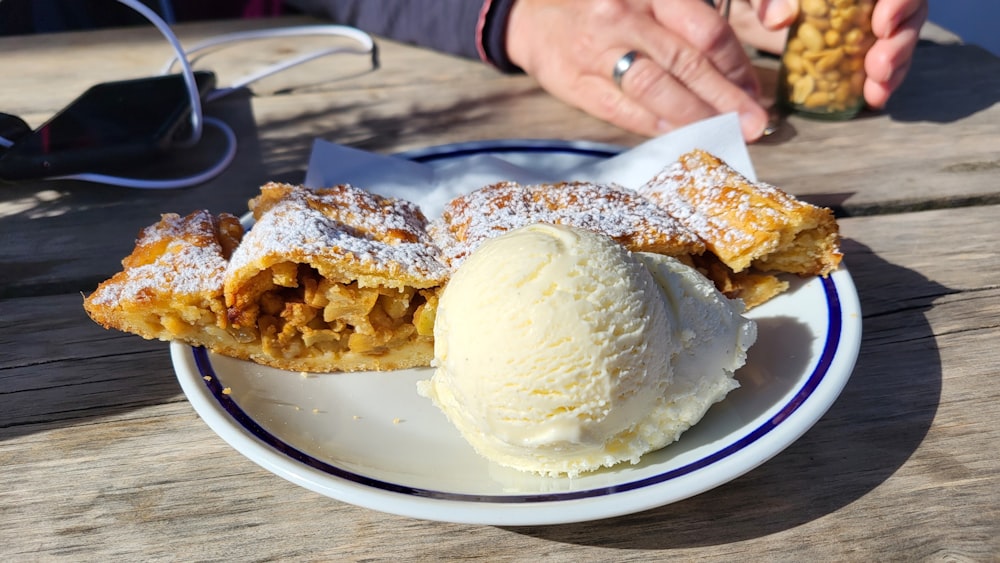 a white plate topped with a dessert covered in powdered sugar