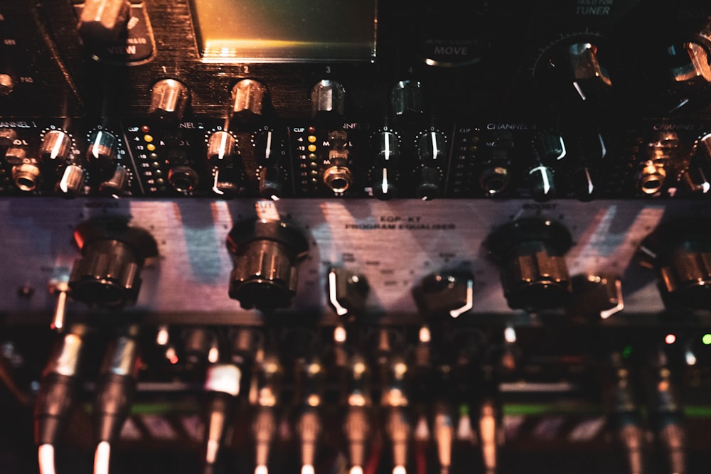 a close up of a control panel with many knobs