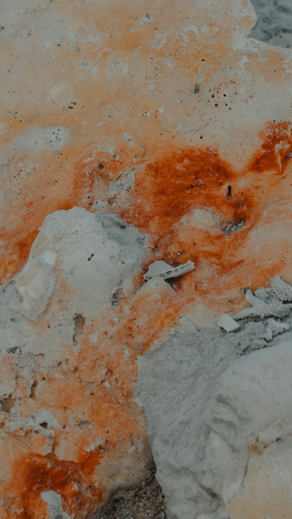 a close up of a rock with orange paint on it